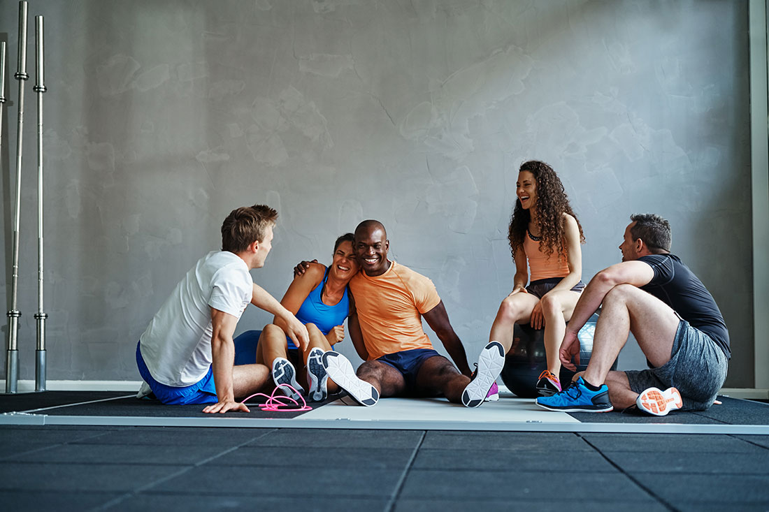 friends-talking-and-laughing-together-on-a-gym